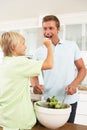 Father & Son Preparing Salad In Modern Kitchen Royalty Free Stock Photo
