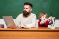 Father and son. Preschool pupil. Teacher teaches a student to use a microscope. Happy family - daddy and son together