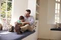 Father And Son Reading Story At Home Together Royalty Free Stock Photo