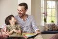 Father And Son Reading Story At Home Together Royalty Free Stock Photo