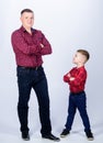 Father and son in red checkered shirt. happy family. childhood. parenting. fathers day. little boy with dad man. Heating Royalty Free Stock Photo