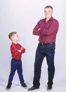 Father and son in red checkered shirt. happy family. childhood. parenting. fathers day. little boy with dad man. Heating Royalty Free Stock Photo