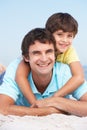 Father And Son Relaxing On Beach Holiday Royalty Free Stock Photo