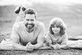 Father and son relaxing on nature in park. Concept of children and parents, happy family. Royalty Free Stock Photo