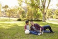 Father and son relaxing with soccer ball in a park Royalty Free Stock Photo