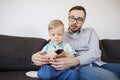 Father and son with remote watching tv at home Royalty Free Stock Photo