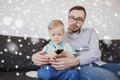 Father and son with remote watching tv at home Royalty Free Stock Photo