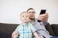 Father and son with remote watching tv at home Royalty Free Stock Photo