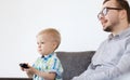 Father and son with remote watching tv at home Royalty Free Stock Photo