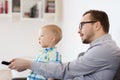 Father and son with remote watching tv at home Royalty Free Stock Photo