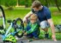 Father and son repairing bike together