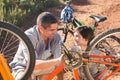 Father and son repairing bike together