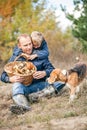 Father and son rest on forest glade after mushrooms pick Royalty Free Stock Photo