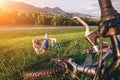 Father with son rest on green meadow after bicykle walk