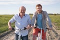 Father and son riding with bicycles outdoor. Royalty Free Stock Photo