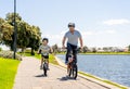 Father and son riding their bikes having fun together in the park by the lake Royalty Free Stock Photo