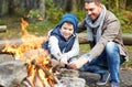 Father and son roasting marshmallow over campfire Royalty Free Stock Photo