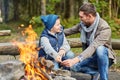 Father and son roasting marshmallow over campfire Royalty Free Stock Photo