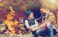 Father and son roasting marshmallow over campfire Royalty Free Stock Photo