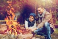 Father and son roasting marshmallow over campfire Royalty Free Stock Photo