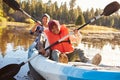 Father And Son Rowing Kayak On Lake Royalty Free Stock Photo