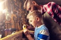 Father and son with ruler measure wood at workshop