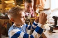 Father and son with ruler measure wood at workshop