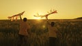 father and son run with kite in hand catching wind n sunset, happy family, boy and dad have fun playing game together in Royalty Free Stock Photo