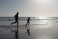 father and son running on beach. daddy with kid boy in sea or ocean. weekend family day. Royalty Free Stock Photo