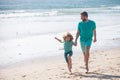 Father and son running on sea. Man famile relations concept.