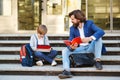Father and son a schoolboy with books sit on the stairs together. The first day of school Royalty Free Stock Photo