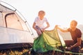 Father and son setting tent on sunset forest glade Royalty Free Stock Photo