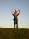 Father with son on shoulders on sundown