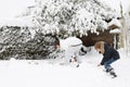 Father and son shoveling snow together in a garden Royalty Free Stock Photo