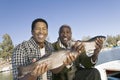 Father And Son Showing Freshly Caught Fish Royalty Free Stock Photo