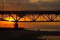 Father and son silhouette walking on beach under Mackinaw Bridge at sunset Royalty Free Stock Photo