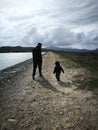 Father and son silhouette walking on trail