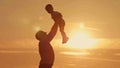 Father and son silhouettes play at sunset beach Royalty Free Stock Photo