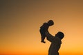 Father and son silhouettes at sunset on a sea beach. Royalty Free Stock Photo