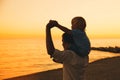 Father and son silhouettes at sunset on a sea beach. Royalty Free Stock Photo