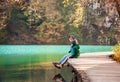 Father with son sit on bridge near the mountain lake, Nature nat