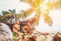 Father and son sit in selfmade hut of branches and play in Robin