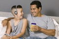 Father and Son sitting on bed Listening to Music Royalty Free Stock Photo