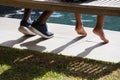 Father and son sitting on bench in the backyard