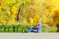 Father and son are sitting on the dock. Autumn, sunny. Side view Royalty Free Stock Photo