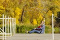 Father and son are sitting on the pier. Autumn sunny day. Side v Royalty Free Stock Photo