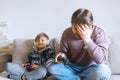 Father And Son Sitting On Sofa In Lounge Playing Video Game Royalty Free Stock Photo