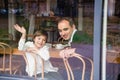 Father and son sitting at the table on a porch Royalty Free Stock Photo