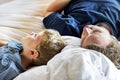Father and son sleeping on a bed Royalty Free Stock Photo