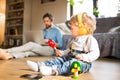 Father and son with smartphone, earphones and laptop. Royalty Free Stock Photo